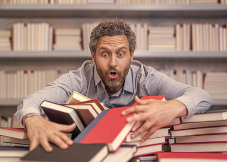 teacher of literature school lesson. college teacher in classroom. school classroom full of books....