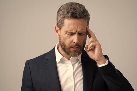 Headache and strain. Headache, tiredness and stress. Businessman in suit with headache. Businessman...
