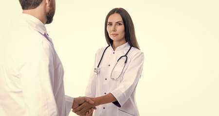 healthcare and medicine. medical deal between two doctor isolated on white. promotion deal. doctor handshake with nurse. healthcare insurance deal. copy spaceの写真素材