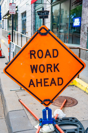 Road work ahead. Sign orange color. Traffic sign on the road. Road sign in the street. Sign says about road work aheadの写真素材