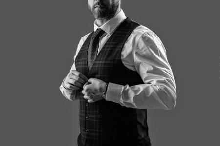 Bespoke suit. Formal menswear. Man businessman in formalwear, cropped view. Business man in elegant tailored vest. Formal suit vest with tie isolated grey. Gentleman menswear. Businesslike Demeanorの写真素材