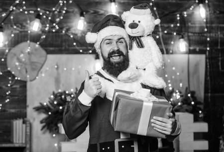 Charity for kids. Winter fundraising ideas. Kindness and generosity. Man bearded Santa claus play soft toy teddy bear. Christmas charity. Charity help. Spread joy happiness. Celebrate new yearの写真素材