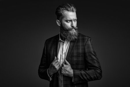 Ambitious man in elegant suit menswear. Formal fashion for man. Suit on menswear model. Stylish man in business suit. Businessman with beard. Bearded man isolated on grey. Formal attireの写真素材