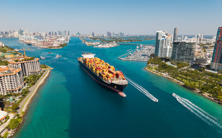 Cargo ship in sea, aerial view. Freight container loaded on cargo vessel. Aerial cargo ship with...