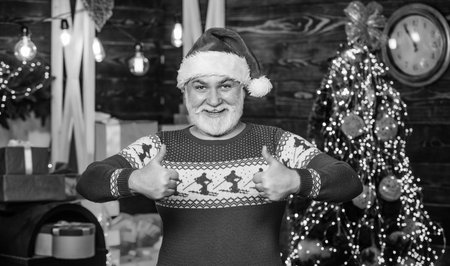 Stick to traditions. December sale. Santa Claus. Gift shop. Man senior Santa claus wear sweater with nordic pattern. Winter traditions. Celebrate new year. Stylish elderly man. Christmas traditionsの写真素材