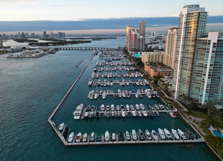 Yacht docked at Miami marina. Aerial view of coastline in Miami. Sailboat cruising along the Miamis shore. Miami skyline above harbor. Famous Miami Beach marine from above. Marina with yachts.の写真素材