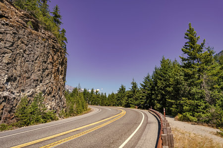 Landscape of rocky mountain and road. Travel destination. Landscape route to North Cascades National Park. Scenic nature. North Cascades nation park. Road leads to Diablo lake with mountain landscapeの写真素材