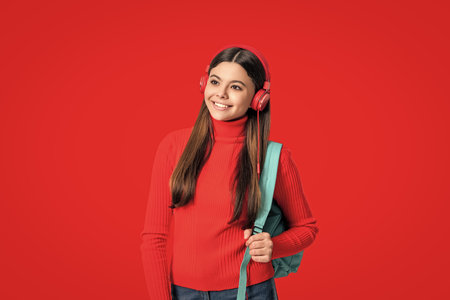 Back to school. Knowledge day. Concept of education. Teen girl student isolated on red. September 1. High school education. Knowledge through eLearning. Teen girl carry backpack. Distance learningの写真素材