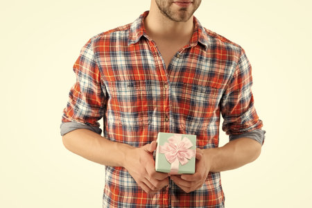 Man hold present box for Valentines day, cropped view. Happy Valentines day. Mens day. Man with gift isolated on white. Romantic gift for date. Present for mens day. Man on February 14の写真素材