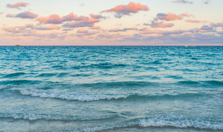 Romantic summer vacation on sunset seascape. Sea sunset on ocean. Sunset seascape at summer vacation. Sunrise with sea beach. Dramatic sunrise horizon at sea. Sea wavesの写真素材