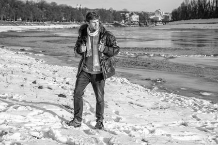man in winter jacket standing outdoors. stylish man in winter jacket outdoor. man in winter jacket