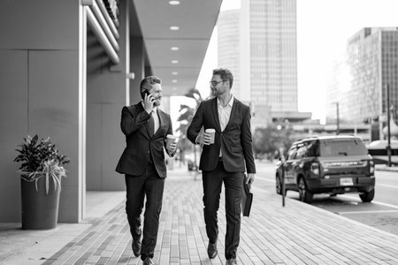 Two CEO businessmen walking and talking in the city. Business men talking. Walking and talking two business men. Colleague walk in New York. Success. Businessmen in suit walking outdoorの写真素材