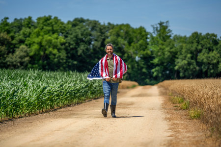 Man with American flag in crop field. Independence day of America. 4th July. American flag and man...