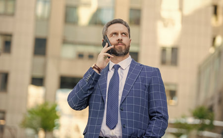 Hispanic business man with phone at office building. Businessman using phone. Man phone conversation...