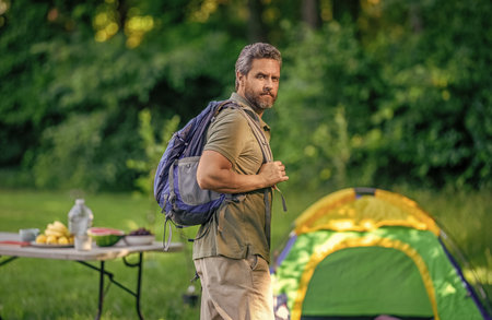 Camp adventure. Hiking lifestyle. Man tourist at campsite. Picnic time. Man having camp picnic in...