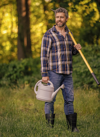 Farmer in spring farm. Man plant tree with shovel. Garden tool. Planting and growing plant. Spring...