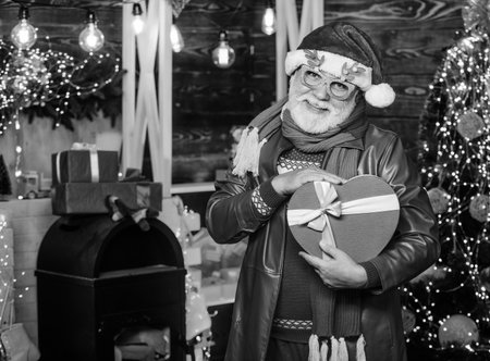 Expressing feelings. presents from santa. bearded man go shopping. xmas gifts. happy new year. Secret santa. winter holiday shopping. party celebration. gifts at Christmas tree. Merry christmasの写真素材