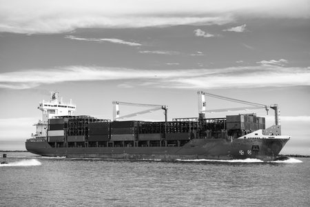 Cargo ship with container in Miami. Freight container loaded on cargo vessel in Miami. Aerial view...