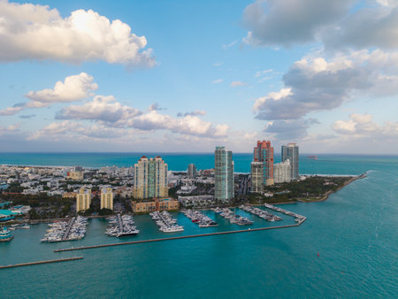Aerial view of luxury yachts in Miami marina. Scenic panorama of boats and skyscrapers in Miami marina. Cruise yacht sailing along the Miami coastline. Miami Beach harbor. Sailboats and yachts at pier.の写真素材