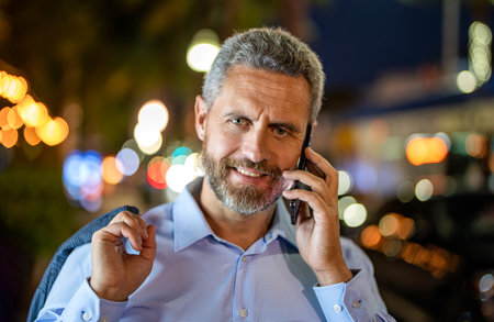 Rich businessman talking on phone outdoor. Businessman using phone. Man phone conversation. Hispanic...