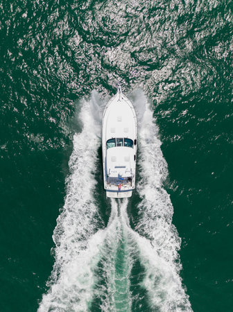 Sea boat go to yacht marina. Yachting and boating marina. Yacht boat sailing. Aerial view luxury motorboat in sea. Summer sea vacation. Boat trip. Luxury lifestyle and traveling. Crystal watersの写真素材