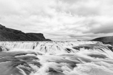 Waterfall river cascade. Iceland nature river flow. Picturesque Gullfoss waterfall creek. Nature wildness. River flow cascade. Waterfall creek flow. Gullfoss waterfall nature. Crystal cascadeの写真素材
