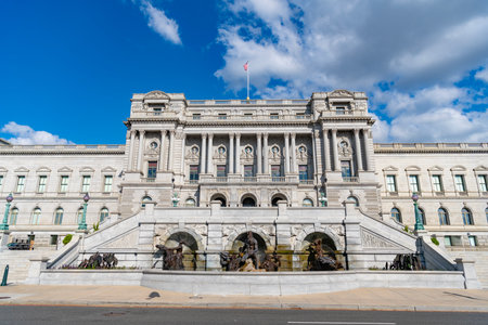 Congress in Washington DC. Congress building under blue sky. Washington DC landmark. American flag above the Congress. Congress historic symbol of American democracyの写真素材