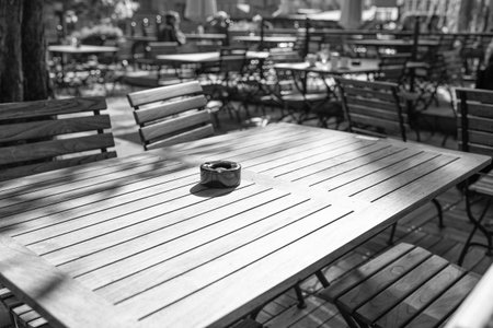 Empty table on terrace of cafe or restaurant with ashtray in smoking area outdoorの写真素材