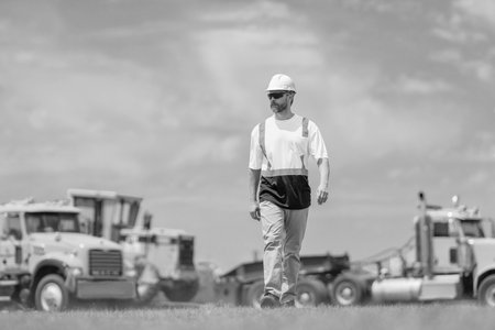 Worker at construction site. Builder construction man. Worker with helmet. Industry worker at construction. Builder civil engineer walk at site building. Supervisor civil engineer. Labor dayの写真素材