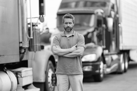 Truck driver. Trucking owner. Professional occupation. Hispanic confident man in front of truck. Semi trucks vehicle. Man owner truck driver. Transportation industry. Man driver near lorry truckの写真素材
