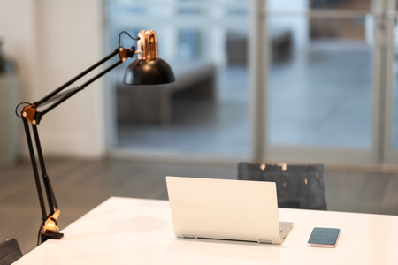 Business office. Open space office. Working office interior. Corporate working space. Laptop on table. Corporate business workplace. Selective focus. Modern workspace with laptop copy spaceの写真素材