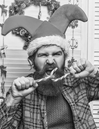 Santa man at New Year eve. December holiday party for man in Santa hat. Xmas man with candy cane....