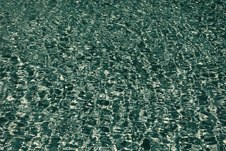 Sea ripples on blue pool background. Sea background. Swimming pool rippled. Summer vacation. Spa resort on summer vacation. Pool side resort with pool water surface background. Sea breezeの写真素材