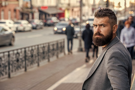 Bearded man going to work. Businessman in business style on street. Business man in urban city. Stylish businessman crossing street, lifestyle. Urban style. City street and stylish man. Copy spaceの写真素材