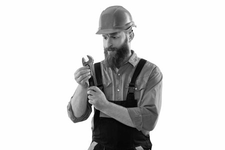 Repairman at workshop. Mechanic working in auto service. Mechanic man hold wrench or spanner. Car mechanic holding wrench tool isolated on white. Car repair service. Using equipmentの写真素材