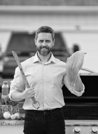 Man roast fish fillet in barbecue at backyard. Grilling and BBQ. Chef cook raw fish tuna in the kitchen. Hispanic chef hold fish tuna fillet. Tuna fillet. Outdoor barbecueの写真素材