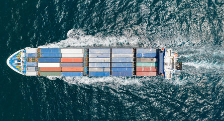 Cargo ship in sea, aerial view. Freight container loaded on cargo vessel. Aerial cargo ship with...