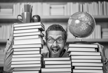 Genius at work. education in school library. man bookworm getting knowledge. teachers and knowledge day. clever school teacher. bookworm man in classroom. school teacher with book literatureの写真素材