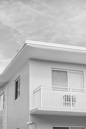 View of building facade. Residential building architecture. Architectural exterior. House exterior fragment. Modern apartment building facade. Apartment building with blue exterior detailの写真素材