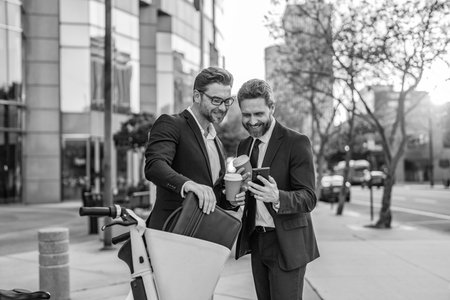 Businessmen checking business chat. Business men freelancing outdoor. Business online. Men working on phone. Businessmen working online. Businessmen in suit with phone. Online working.の写真素材