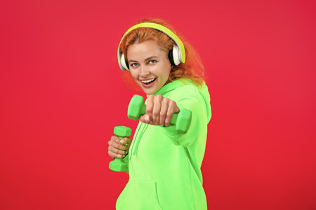 Woman training with dumbbell. Workout girl. Strong sporty sportswoman. Woman do sport training...