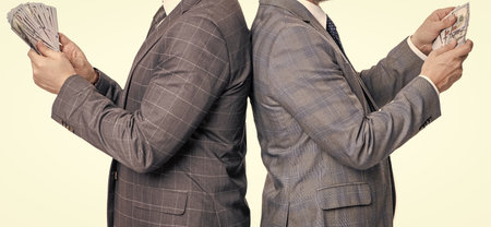 businessmen with money isolated on white. businessmen invest money in business. successful business brings money. successful business men investors. financial investment. cropped viewの写真素材