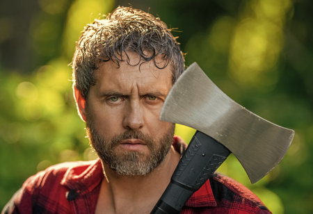 Lumberjack axe sweating. Man with logging axe. Hardworking man. Logging lumberjack man outdoor....