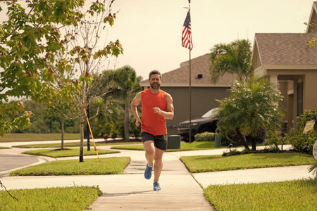 Man runner running training during the run. Sport fit runner jogging. Jogging activity. Running man run down the neighborhood. Jogging man enjoy the freedom of running outdoor. Staminaの写真素材