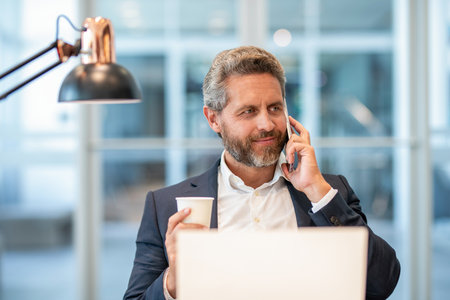Man reply phone call. Busy businessman talking on phone in the office. Businessman using phone. Man phone conversation. Hispanic business man with smartphone at coffee break. Business communicationの写真素材