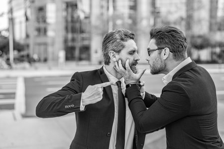 Businessmen having conflict in business with fight aggression conflicting outdoorの写真素材