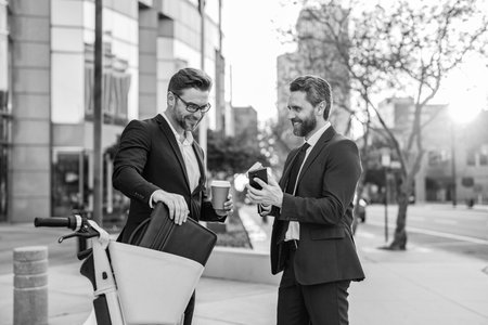Business men freelancing outdoor. Business online. Men working on phone. Businessmen working online. Businessmen in suit with phone. Online working. Businessmen checking business chat. Stock reportsの写真素材