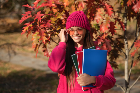 autumn is time to study. education and knowledge. school education. back to school. autumn girl holding school homework. education for college student. teen girl in autumn outdoor. Graduation dayの写真素材