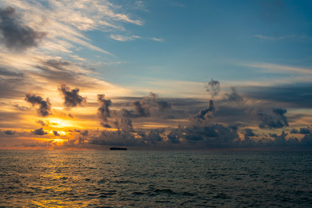 Cloudy sunset sky and seascape at summer vacation. Skyscape with sea sunrise. Calm horizon at sea nature. Romantic summer vacation on seascape. Sunrise sky horizon. Sea sunset view.の写真素材