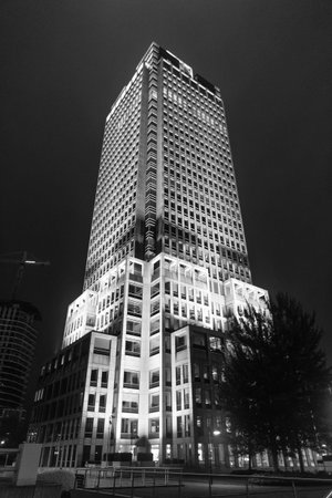 Business skyscraper at night. Modern evening building. Skyscraper in city. City downtown with...